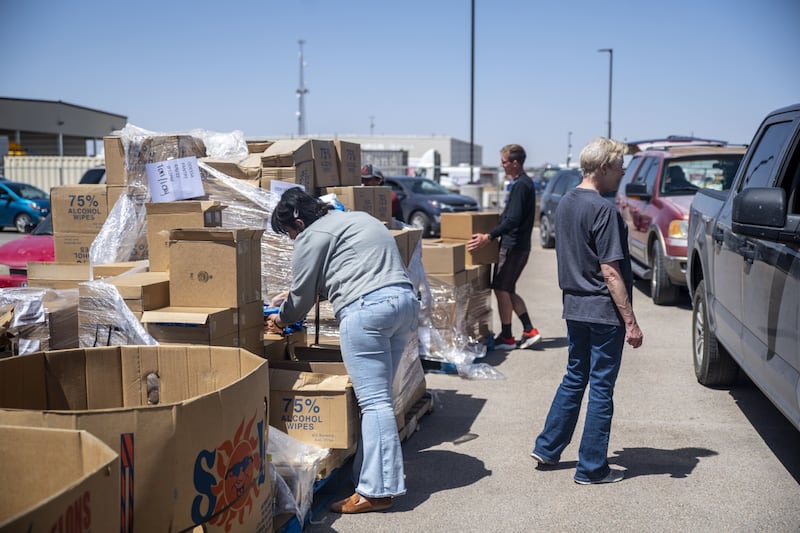 Volunteers gather food to hand out at a West Texas Food Bank drive-through in Odessa, Texas. Bloomberg