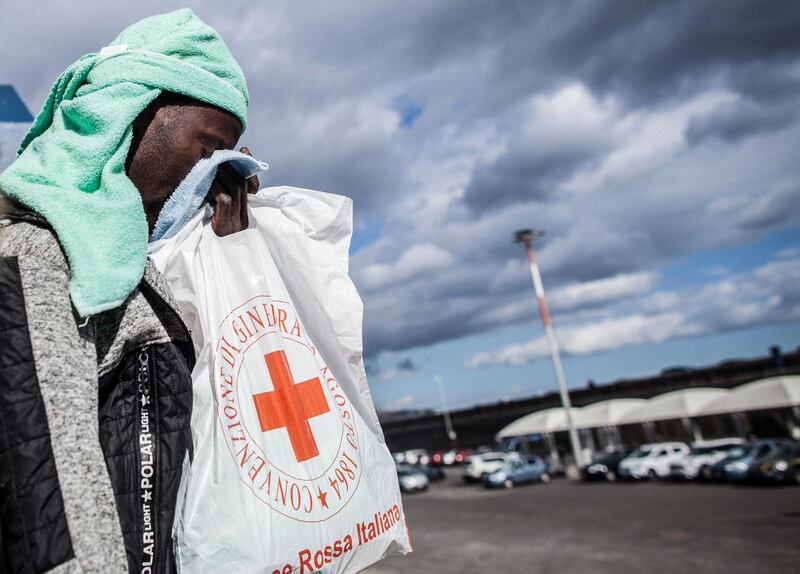 A migrant reacts as he disembarks from the Dutch-flagged Sea Watch 3 NGO rescue vessel after it docked on January 31, 2019 in the Sicilian port of Catania, southeastern Sicily.
 A ship carrying 47 rescued migrants docked in the Sicilian port of Catania on January 31 with the crew fearing legal action as Italy's far-right interior minister tries to stop new arrivals. The ship which had been waiting off the coast of Sicily with people it rescued in the Mediterranean on January 19, was finally given permission to dock in Catania after six other countries agreed to take them in. / AFP / Federico Scoppa
