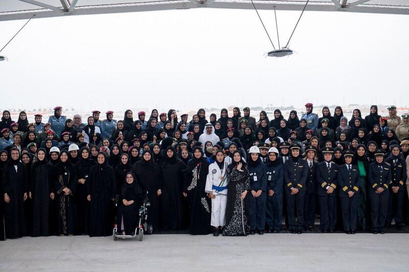 Sheikh Mohamed bin Zayed, Crown Prince of Abu Dhabi and Deputy Supreme Commander of the Armed Forces, stands for a photograph with Emirati ministers, FNC members and women from the civil and military sectors, on Emirati Women's Day in 2016. Courtesy Sheikh Mohamed bin Zayed Twitter