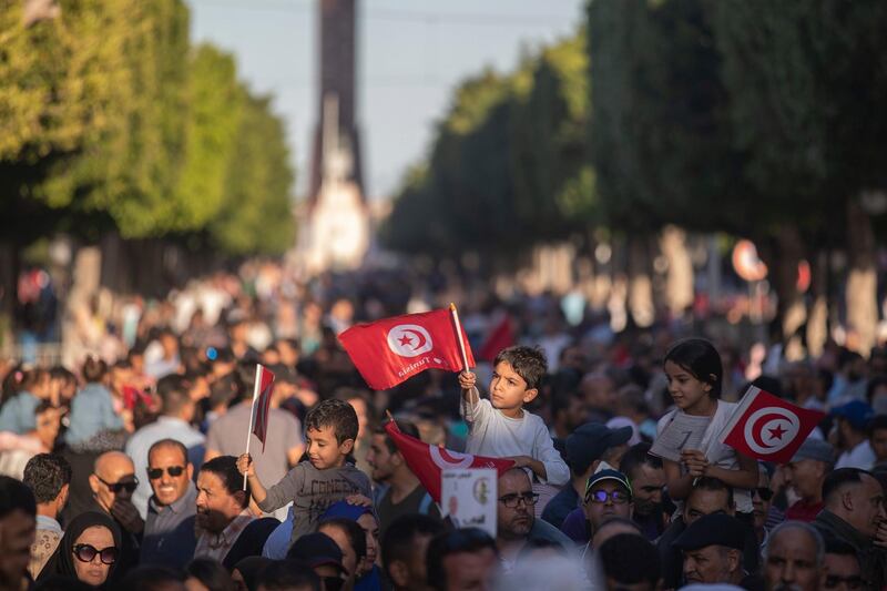 Children wave Tunisian flags as supporters of independent Tunisian Presidential candidate Kais Saied attend a rally on the last day of campaigning before the second round of the presidential elections, in Tunis, Tunisia. AP Photo