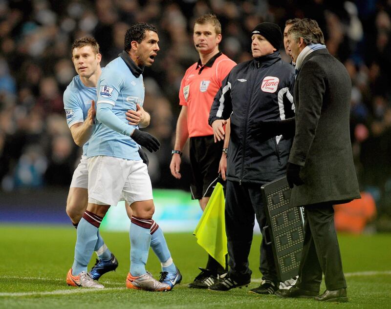MANCHESTER, ENGLAND - DECEMBER 04:  Carlos Tevez of Manchester City has words with Manchester City Manager Roberto Mancini after being substituted for team mate James Milner during the Barclays Premier League match between Manchester City and Bolton Wanderers at the City of Manchester Stadium on December 4, 2010 in Manchester, England.  (Photo by Clive Mason/Getty Images) *** Local Caption *** Roberto Mancini;Carlos Tevez;James Milner