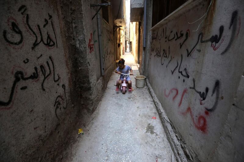 A Palestinian girl rides her bike in the Balata refugee camp near the West Bank city of Nablus. EPA