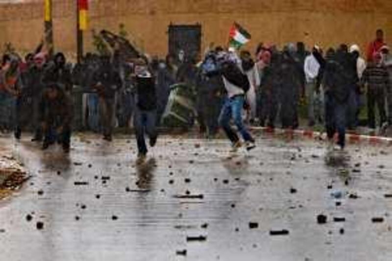 Israeli Arab youths throw rocks at police during an Israeli right-wing extremists march in the northern Israeli Arab village of Umm El-Fahm Tuesday, March 24, 2009. Police dispersed rock-throwing Israeli-Arab youths with stun grenades and tear gas after a group of Israeli extremists marched through an Arab town demanding that residents show loyalty to the Jewish state. (AP Photo/Bernat Armangue) *** Local Caption ***  JRL106_MIDEAST_ISRAEL_PALESTINIANS_PROTESTS.jpg