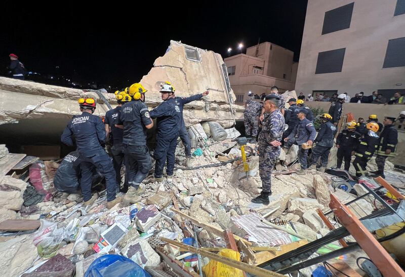 A crane, bulldozer and lorries were being used to remove rubble from the site. Reuters