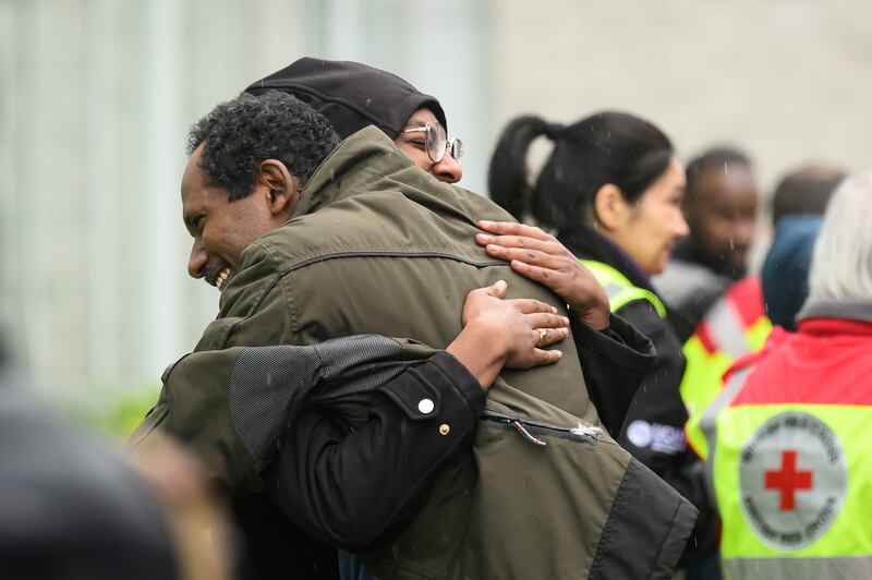 A man is greeted by a family member after arriving at Stansted Airport from Sudan. Getty