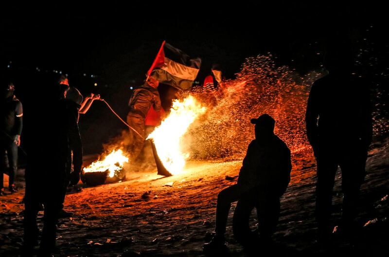 Palestinian protesters take part in a night demonstration near the fence along the border with Israel, in Rafah in the southern Gaza Strip. AFP