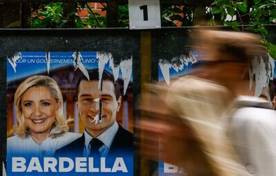 Posters of Marine Le Pen, leader of the French extreme right party National Rally, and Jordan Bardella, outside a polling station in Malakoff, near Paris. EPA 