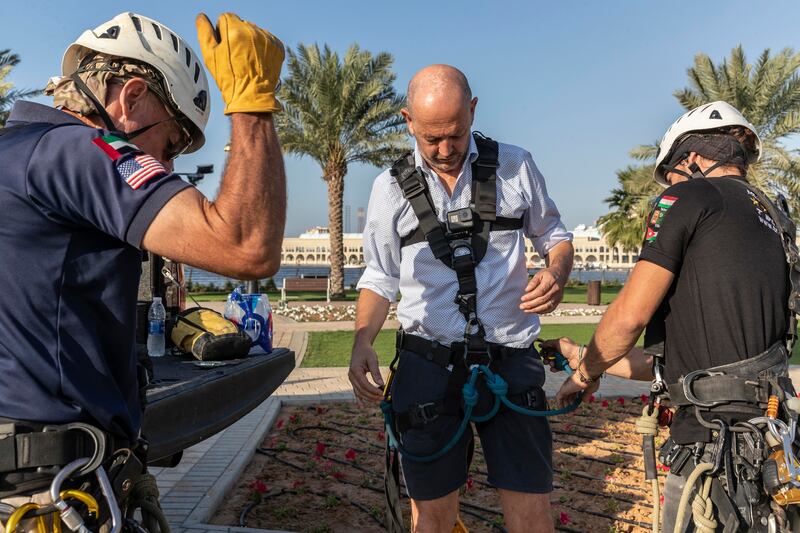 The National's Andrew Scott gets ready to climb up the 123-metre flag pole on Sharjah's Flag island. All photos: Antonie Robertson / The National
