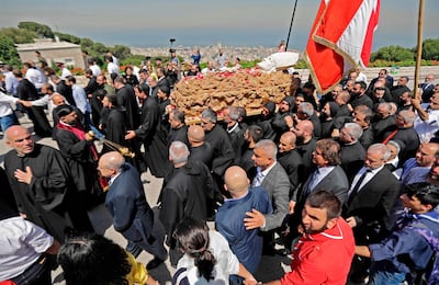 Lebanese monks carry the coffin of late Maronite Patriarch Cardinal Nasrallah Sfeir on April 15, 2019 at the Maronite Patriarchate in the mountain village of Bkerki, northeast of Beirut. Lebanon's former Maronite patriarch Nasrallah Boutros Sfeir, who wielded considerable political influence during the country's civil war and was an ardent advocate of a Syrian troop withdrawal, died on May 12 at the age of 99, the church said.  / AFP / JOSEPH EID
