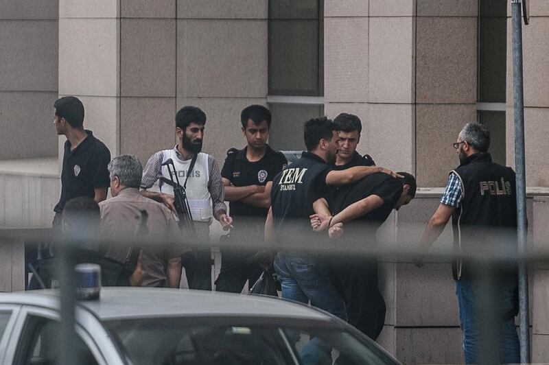 A Turkish soldier who allegedly took part in an attempted military coup arrives with his hands bound behind his back at the Istanbul Justice Palace on July 20, 2016. Ozan Kose / AFP