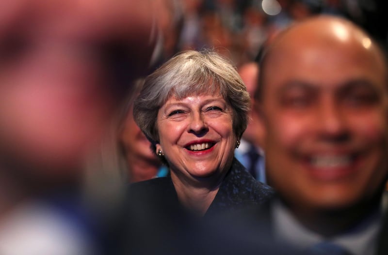 Britain's Prime Minister Theresa May smiles as she listens to speeches at the Conservative Party's conference in Manchester, October 2, 2017. REUTERS/Hannah McKay