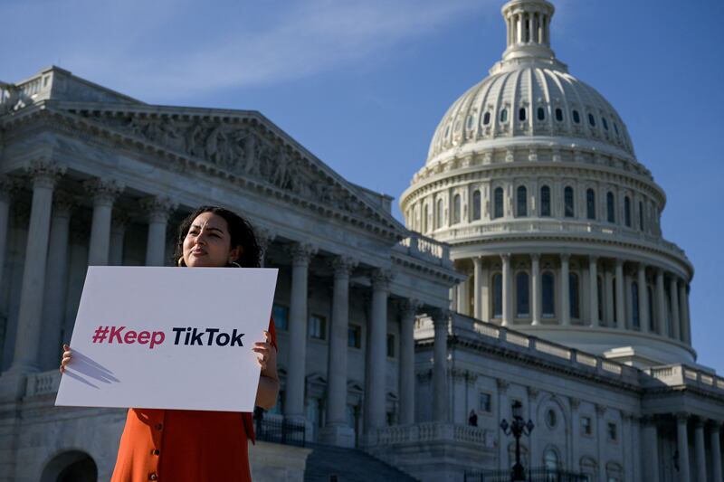 A TikTok supporter demonstrates outside the US Capitol opposing legislation aimed at banning the app in Congress. Reuters