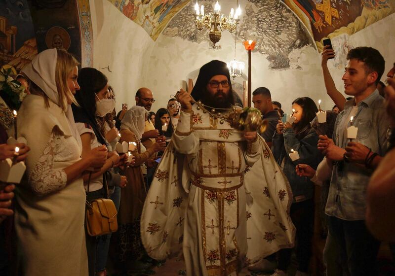 A Greek Orthodox priest swings a censer as he celebrates Easter night Mass at the ancient monastery of Our Lady of Hamatoura, north of Beirut. AFP