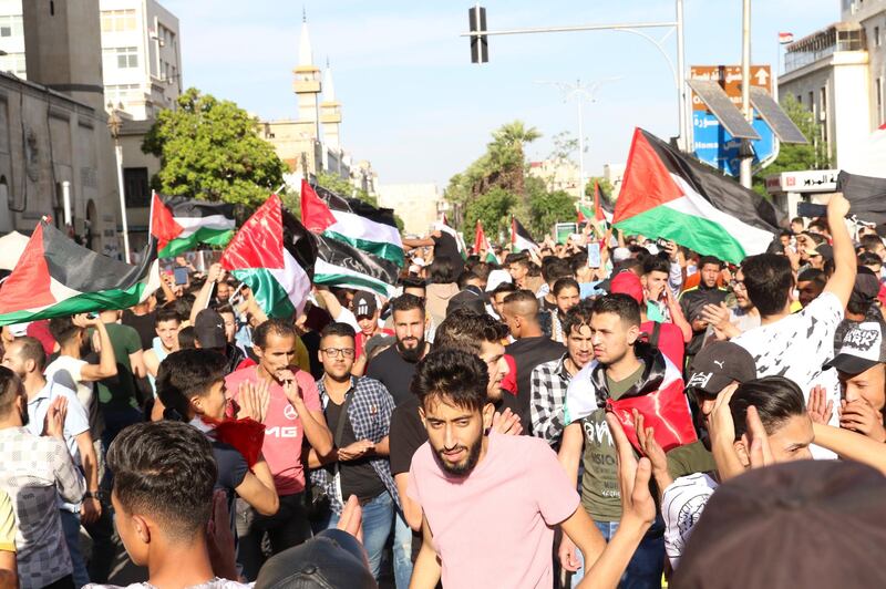 Thousands of Syrians and Palestinians, holding flags and posters, protest against Israel's attacks on the Palestinian Gaza Strip as they march from the Hamidiya souq towards the Umayyad Square in Damascus, Syria. EPA