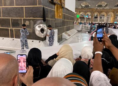 Muslim pilgrims film the Black Stone located on the Kaaba, the cubic building at the Grand Mosque, in the Saudi Arabia's holy city of Mecca, Tuesday, July 5, 2022.  Saudi Arabia is expected to receive one million Muslims to attend Hajj pilgrimage, which will begin on July 7, after two years of limiting the numbers because coronavirus pandemic.  (AP Photo / Amr Nabil)