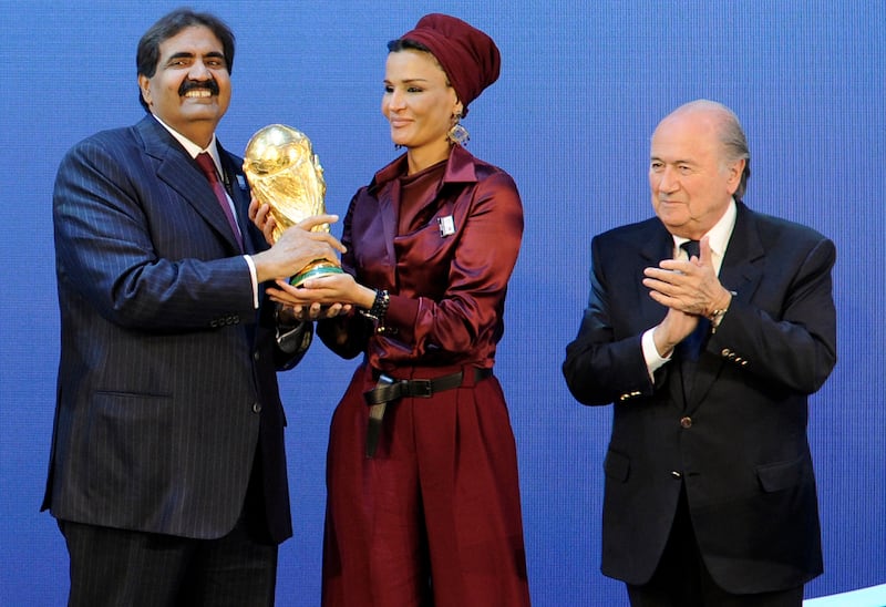 Qatar's Emir Sheikh Hamad bin Khalifa Al Thani (R) and his wife Sheikha Moza bint Nasser Al Missned (C) receive the World Cup trophy from Fifa president Joseph Blatter after the official announcement that Qatar will host the 2022 World Cup at the Fifa headquarters in Zurich on December 2, 2010. Fabrice Coffrini / AFP Photo
