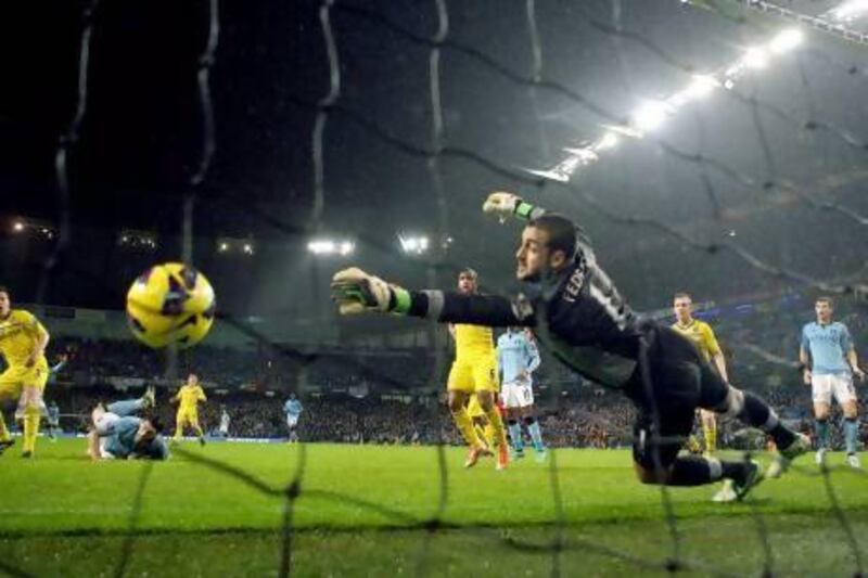 Manchester City's Gareth Barry scores a header past Reading goalkeeper Adam Federici. Julian Finney / Getty Images;