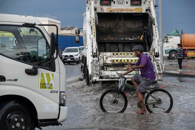 A cyclist travels amid clean-up efforts in Dubai. Antonie Robertson/The National