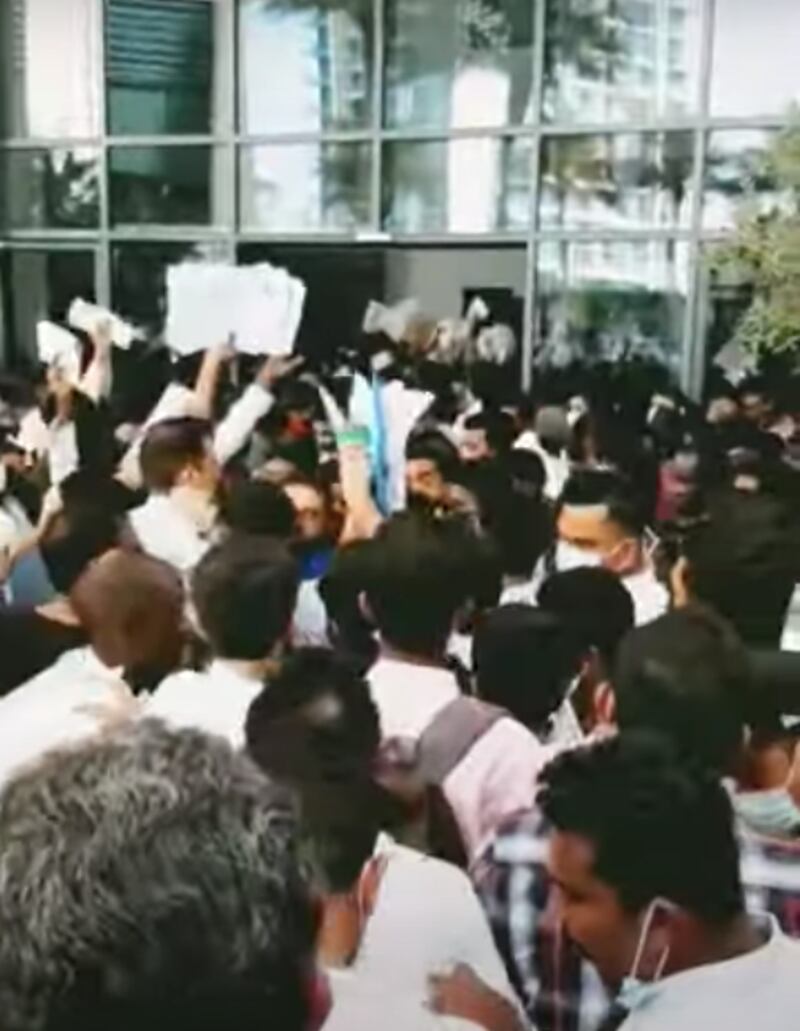 Jobseekers wave their CVs outside the Vida Emirates Hills Hotel on Saturday Photo: Sai Sagar
