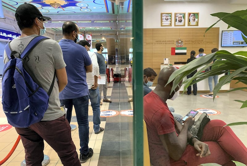 DUBAI, UNITED ARAB EMIRATES , July 21 – 2020 :- People wearing protective face mask and waiting for their turn for the medical test for the visa renewal at the Medical Examination Center for Residency at Ibn Battuta Mall in Dubai.  (Pawan Singh / The National) For News/Standalone/Online/Stock