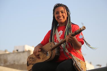 Asmaa Hamzoui plays gnawa music's  signature instrument, the gimbri - a three-stringed lute. Courtesy Ajabu