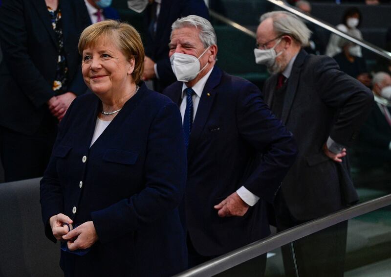 Outgoing German Chancellor Angela Merkel arrives to take her seat during a session at the Bundestag. AFP