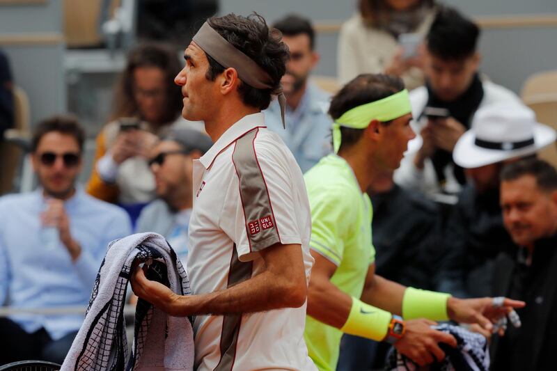 Federer and Nadal walk to their benches during the changeover. AP Photo