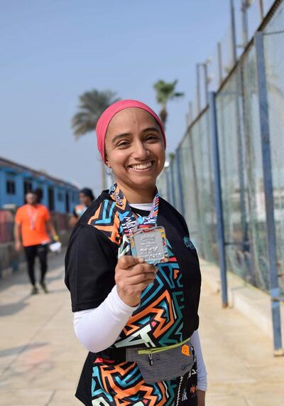 Aya Ayman with her half marathon medal. Courtesy Marathon Cairo
