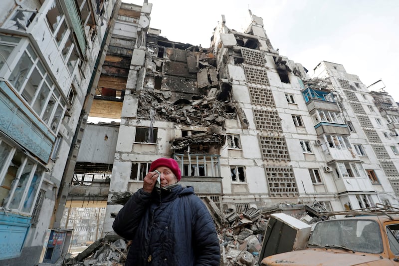 Valentina Demura, 70, near the ruins of her home in apartment block in the besieged southern port city of Mariupol. Reuters