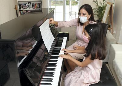 Former cabin crew Mercedes Basutto with student Hannah aged 8 was made redundant and has now switched careers as a piano teacher in Dubai on June 22nd, 2021. Chris Whiteoak / The National. 
Reporter: N/A for News