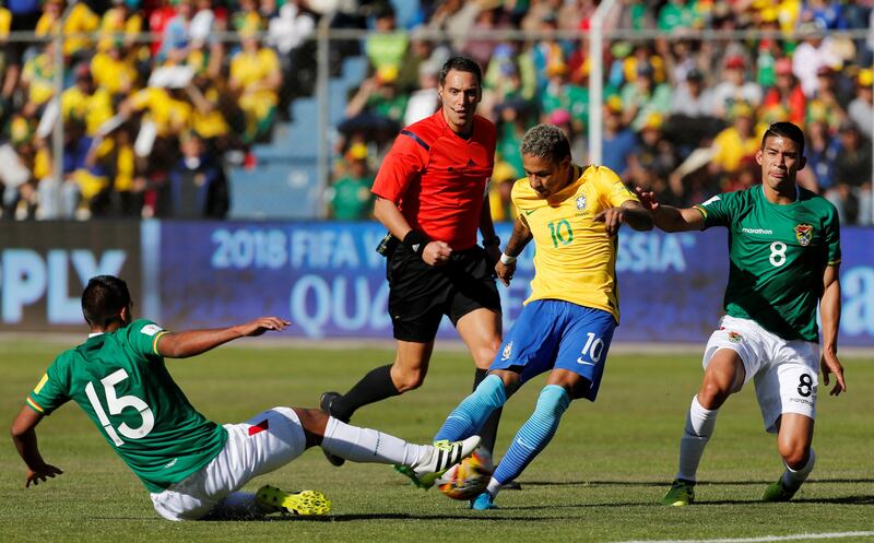 Neymar's attempted to shot at goal is blocked by Cristhian Machado. David Mercado / Reuters