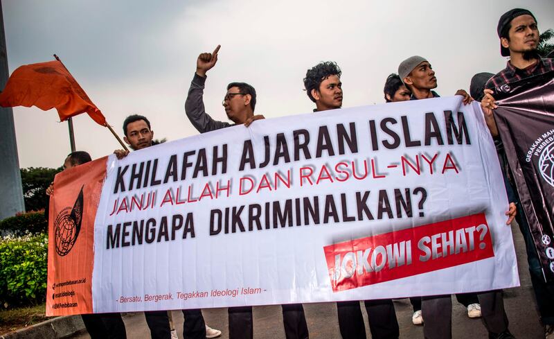 Muslim student activists take part in an anti-government rally in Jakarta on July 12, 2017, after President Joko Widodo signed a new law to disband Hizb ut-Tahrir Indonesia, the local branch of a radical Islamist group which seeks to unify all Muslims into a caliphate. Bay Ismoyo / AFP Photo