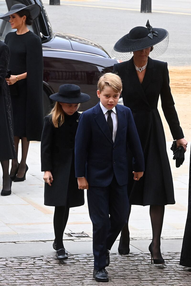 Catherine, Princess of Wales, arrives at the funeral of Queen Elizabeth II with Princess Charlotte and Prince George. AFP