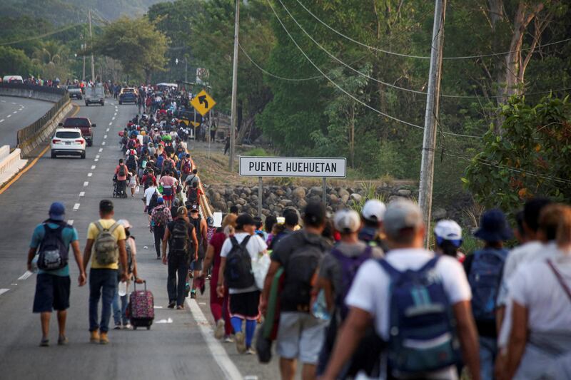 Migrants, held up for months in southern Mexico, walk in file to Mexico City to speed up their applications for US asylum. Reuters