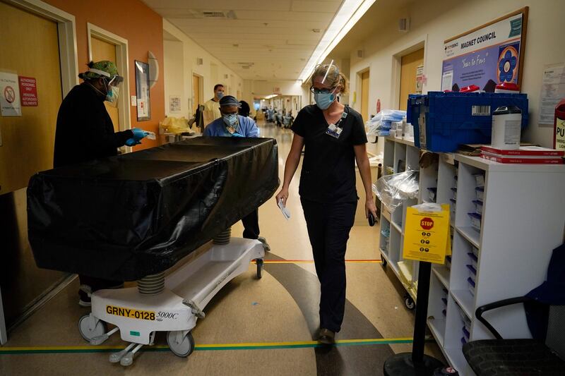 Chaplain Kristin Michealsen leaves a Covid-19 unit after talking to a family member of a deceased patient at Providence Holy Cross Medical Center in the Mission Hills section of Los Angeles. AP Photo