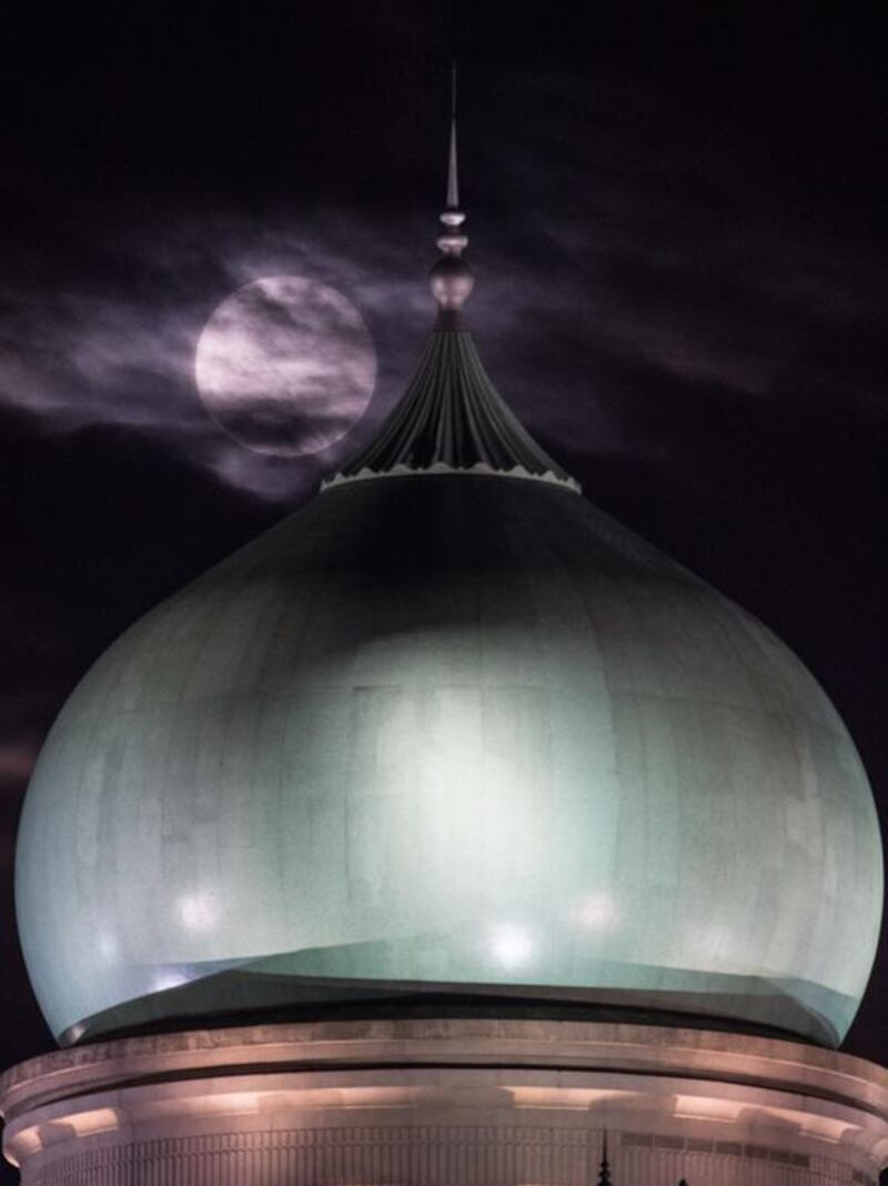 The supermoon is seen past the dome of the prime minister’s Office complex in Putrajaya, Malaysia on November 14. Mohd Rasfan / AFP Photo