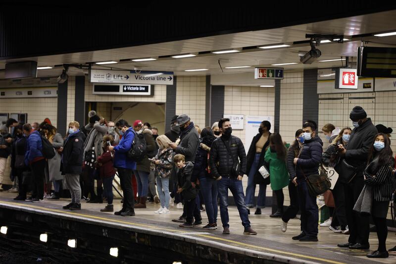 Passengers wait on the platform at Victoria London Underground station in central London. AFP