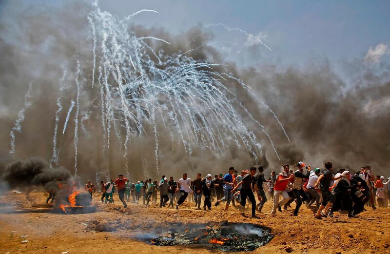 -- AFP PICTURES OF THE YEAR 2018 --

Palestinians run for cover from tear gas during clashes with Israeli security forces near the border between Israel and the Gaza Strip, east of Jabalia on May 14, 2018, as Palestinians protest over the inauguration of the US embassy following its controversial move to Jerusalem.  - 
 / AFP / MOHAMMED ABED
