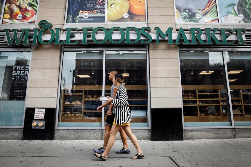 People pass by a Whole Foods store in New York City, U.S., August 28, 2017.   REUTERS/Brendan McDermid