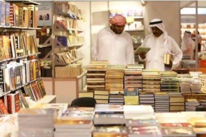 Visitors browse books at the Sharjah International Book Fair held at Sharjah Expo Centre. Pawan Singh / The National