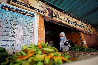 A woman buys vegetables from a cafe transformed into a vegetable shop as venues have been shut following the outbreak of the coronavirus disease. Reuters, file