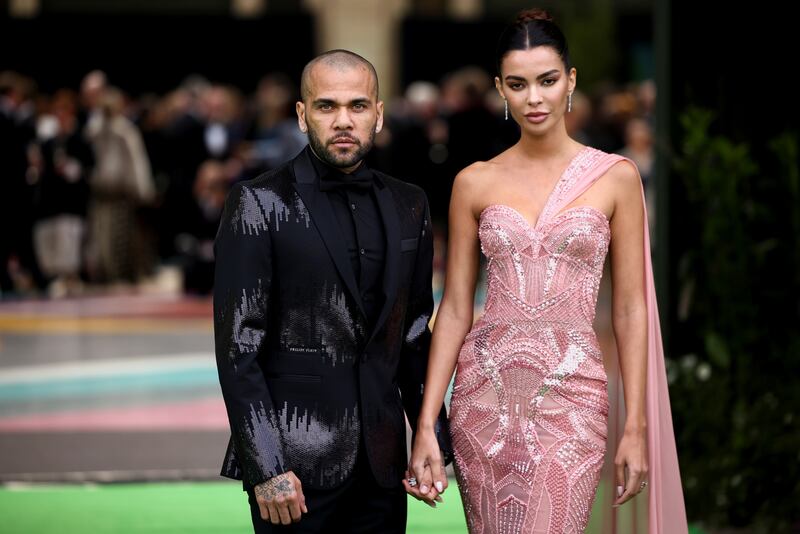 Football player Dani Alves and his wife, Joana Sanz, step on to the green carpet. Reuters