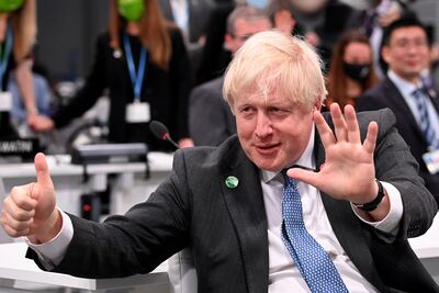 The UK's then-prime minister Boris Johnson signals 1.5°C during Cop26 talks in Glasgow two years ago. Getty Images
