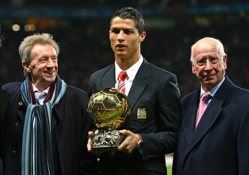 Cristiano Ronaldo is crowned the European Footballer of the Year in 2008, flanked by previous winners and former Manchester United players Denis Law (L) and Bobby Charlton. Getty Images