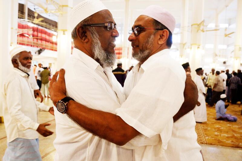 Muslims greet each other after Eid-al-Fitr prayers at the Grand Mosque in Colombo, Sri Lanka. EPA