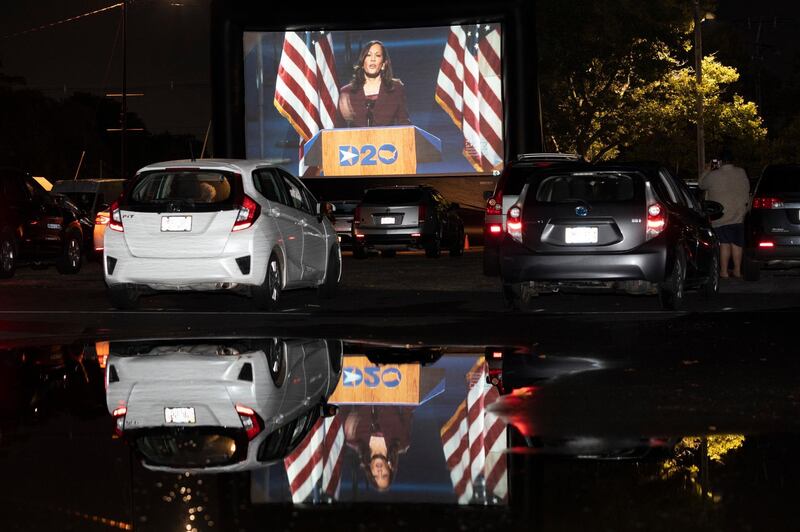 Democratic vice presidential nominee Kamala Harris speaks during the Democratic National Convention, as seen on a screen at a drive-in watch party for the convention at Suffolk Downs, in Boston. AP Photo