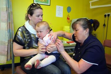 A 14-month-old receives the combined Measles Mumps and Rubella (MMR) vaccination near Swansea, Wales. AFP