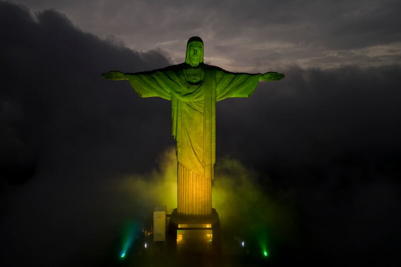 Christ the Redeemer statue is illuminated in the colours of the Brazilian national flag to honour late football legend Pele, in Rio de Janeiro, Brazil, on Thursday, December  29, 2022. AP