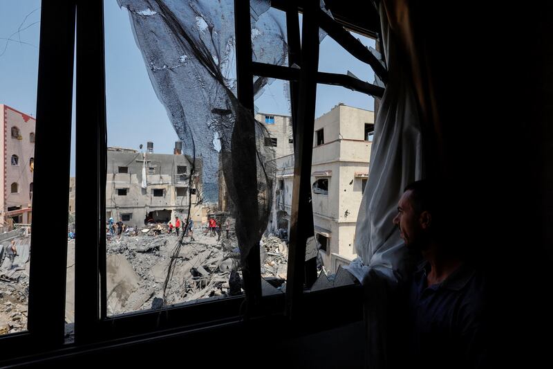 A Palestinian looks out at the remains of a house in Gaza City hit by an Israeli air strike. Reuters