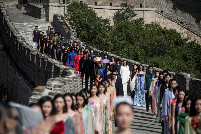 Models walk along the Great Wall of China during the Pierre Cardin China Legend 40th Anniversary Fashion Show on September 20, 2018. AFP